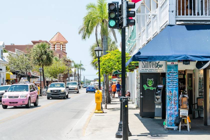 Duval Street road, sidewalk in Florida keys city travel, sunny day on street, people